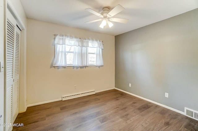 unfurnished bedroom with visible vents, baseboards, a closet, and wood finished floors