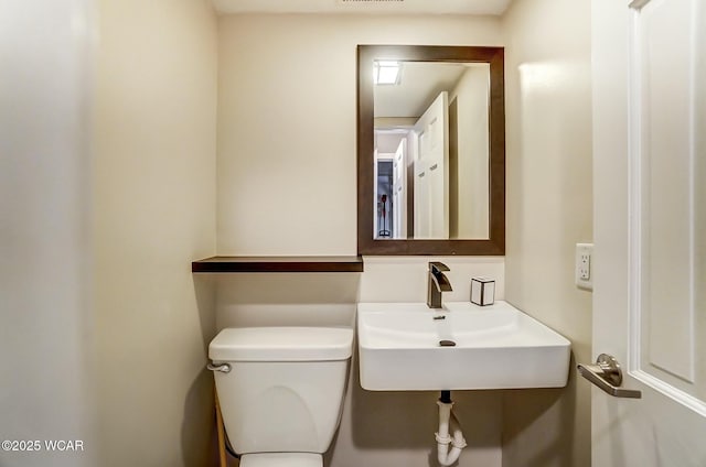 bathroom with toilet and a sink