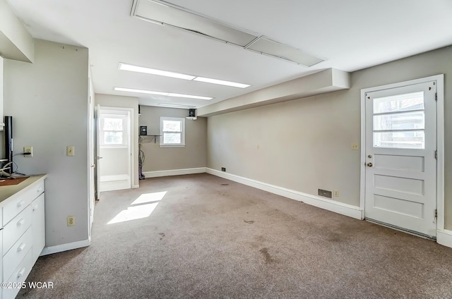 below grade area featuring baseboards and carpet floors