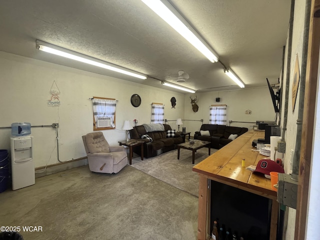 2845 Greely Chapel Rd, Lima, OH 45806 - living room featuring concrete flooring, a textured ceiling, and cooling unit