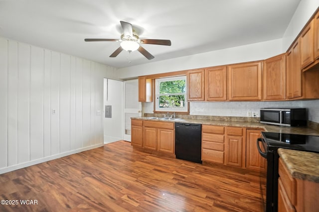 806 Tremont Ave, Lima, OH 45801 - kitchen with black appliances, dark wood-style floors, a ceiling fan, and brown cabinetry
