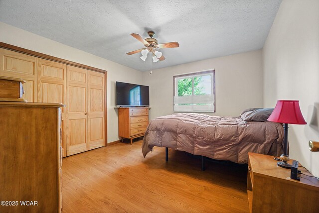 18509 State Highway 67, Upper Sandusky, OH 43351 - bedroom with light wood-style floors, a closet, a textured ceiling, and ceiling fan