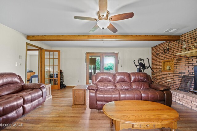 18509 State Highway 67, Upper Sandusky, OH 43351 - living area with light wood-style flooring, beamed ceiling, ceiling fan, and brick wall