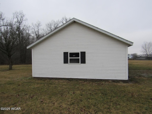 view of side of property with a lawn