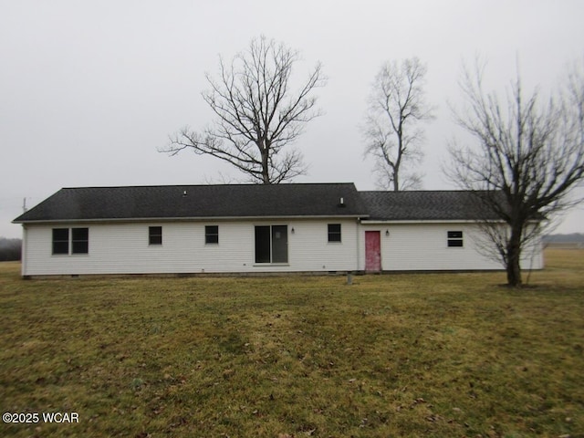 back of house featuring crawl space and a lawn