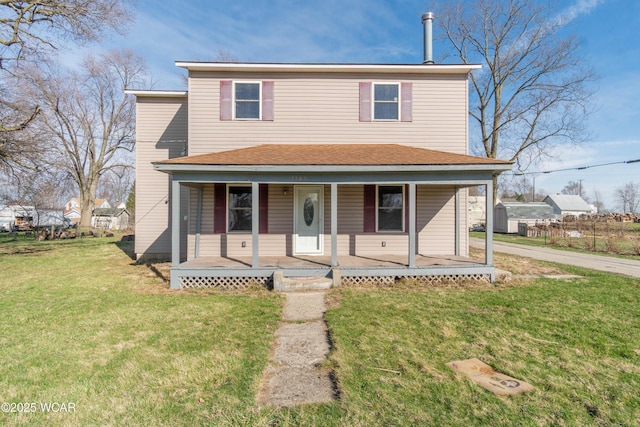 traditional-style home with a front yard and covered porch