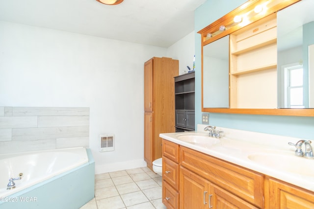 bathroom featuring tile patterned flooring, a whirlpool tub, a sink, and double vanity