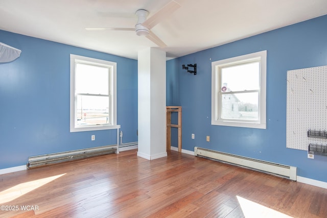 unfurnished room featuring a baseboard radiator, a wealth of natural light, a baseboard heating unit, and ceiling fan