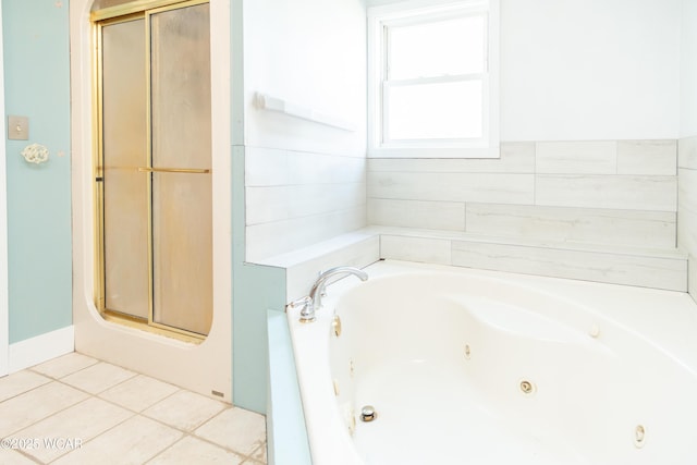 bathroom with a jetted tub, tile patterned flooring, and a stall shower