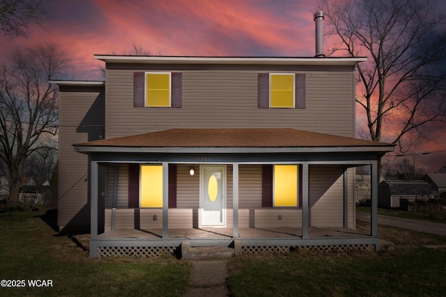 view of front facade with a lawn and a porch