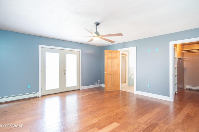 interior space with french doors, baseboards, light wood-style flooring, baseboard heating, and ceiling fan