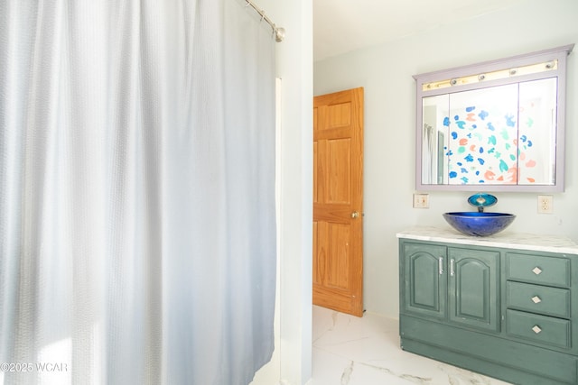 bathroom featuring marble finish floor and vanity