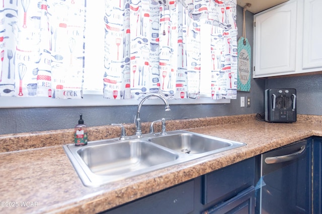 kitchen featuring dishwasher, a sink, white cabinetry, and blue cabinetry