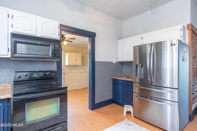 kitchen with ceiling fan, light wood finished floors, white cabinetry, and black appliances