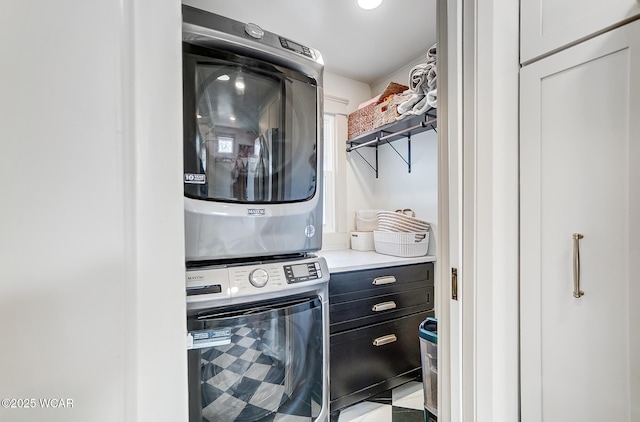 laundry area with stacked washer and clothes dryer