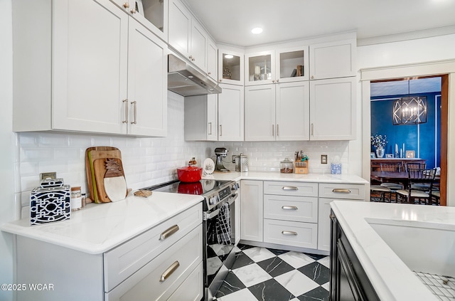 kitchen featuring white cabinetry, stainless steel electric range oven, decorative backsplash, and decorative light fixtures