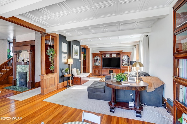 living room featuring hardwood / wood-style floors and decorative columns