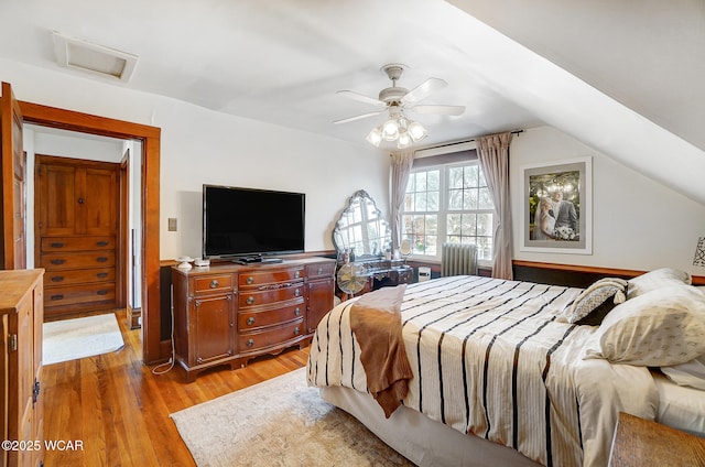 bedroom featuring lofted ceiling, light hardwood / wood-style floors, and ceiling fan