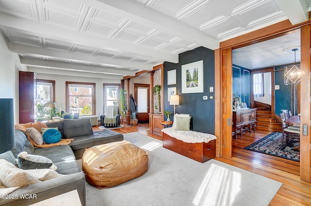 living room featuring an inviting chandelier and light hardwood / wood-style floors