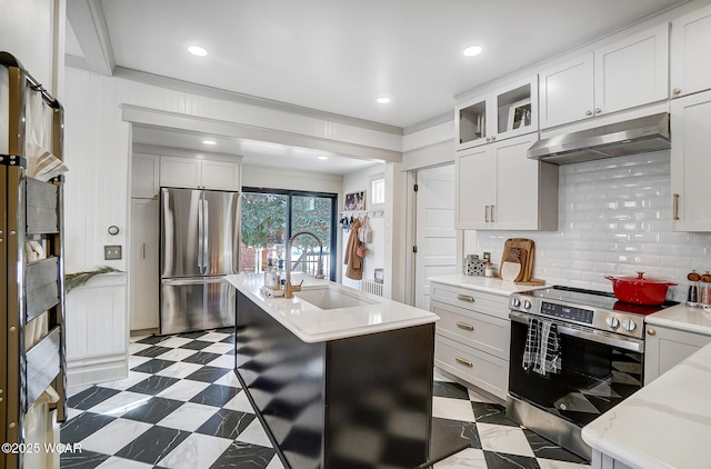 kitchen featuring white cabinetry, sink, stainless steel appliances, and a center island with sink