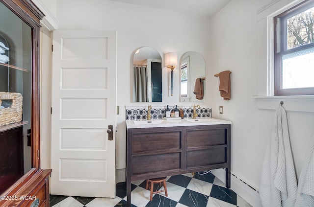 bathroom featuring vanity, a baseboard heating unit, and a shower with curtain