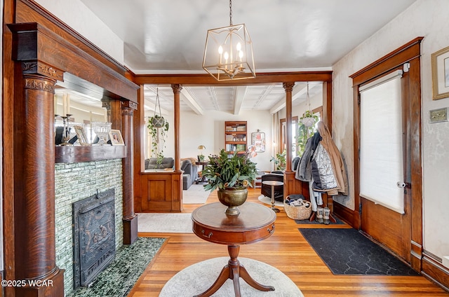 foyer featuring a notable chandelier, beam ceiling, and wood-type flooring