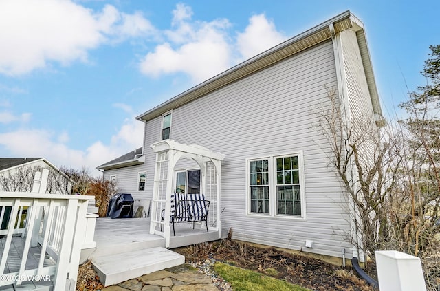 back of house with a pergola and a deck