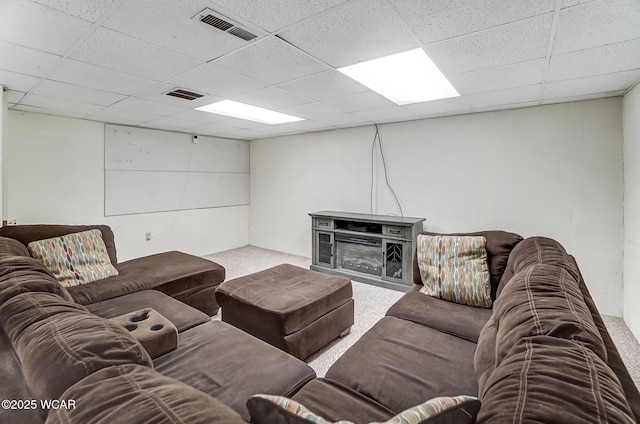 living room with carpet and a drop ceiling