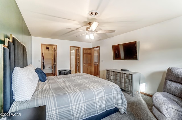 carpeted bedroom featuring ceiling fan and a spacious closet