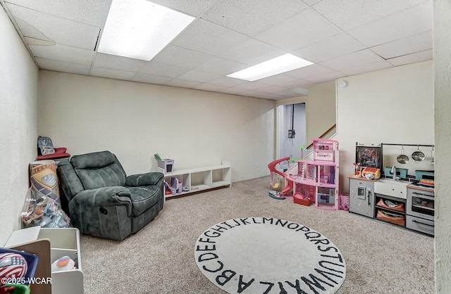 game room with carpet flooring and a drop ceiling