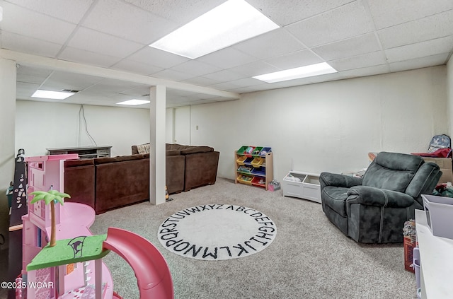 playroom with carpet floors and a drop ceiling