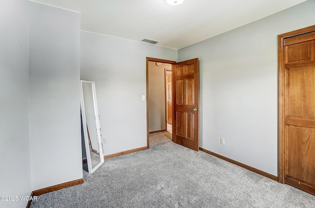 unfurnished bedroom featuring light carpet