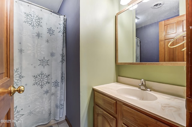 bathroom with tile patterned floors and vanity