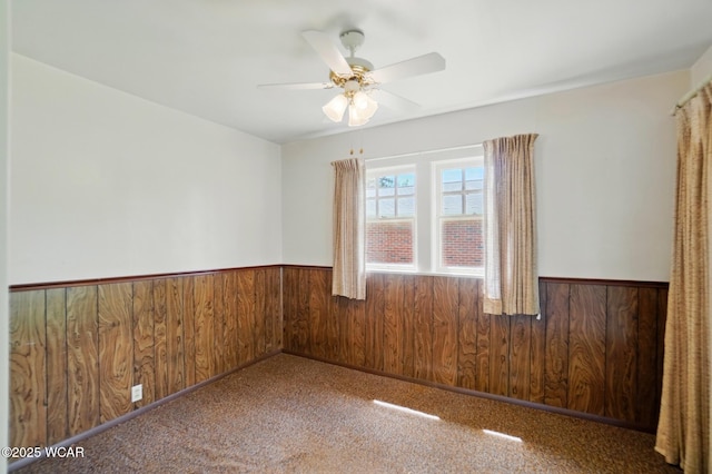 635 Close Ave, Lima, OH 45805 - empty room with wooden walls, carpet floors, a ceiling fan, and wainscoting