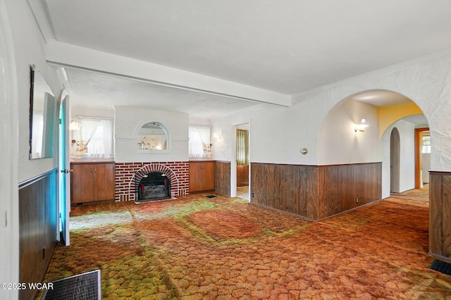 635 Close Ave, Lima, OH 45805 - unfurnished living room with wainscoting, carpet, and a fireplace