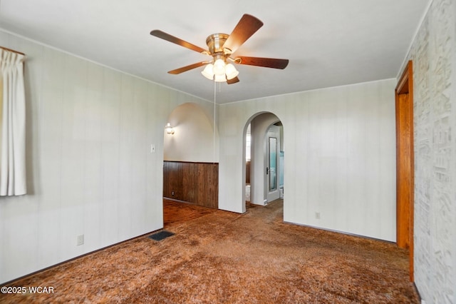 635 Close Ave, Lima, OH 45805 - carpeted empty room featuring arched walkways, ornamental molding, a ceiling fan, and visible vents