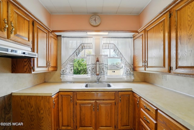 635 Close Ave, Lima, OH 45805 - kitchen with light countertops, brown cabinets, under cabinet range hood, and a sink
