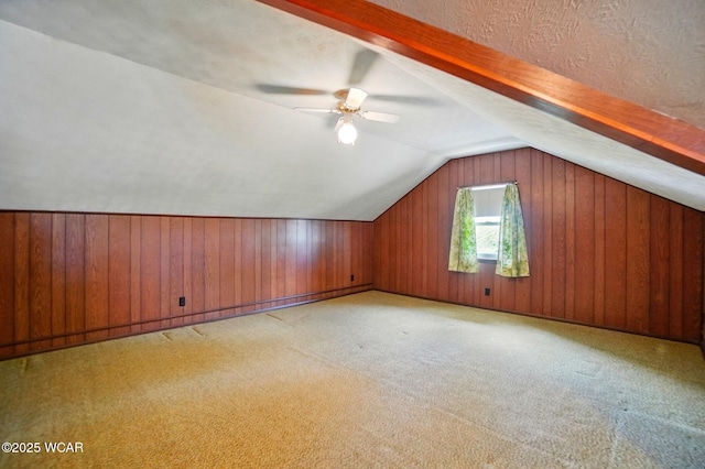 635 Close Ave, Lima, OH 45805 - additional living space featuring wooden walls, a ceiling fan, vaulted ceiling, and light colored carpet