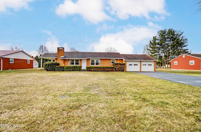 ranch-style house with a front yard, an attached garage, driveway, and a chimney