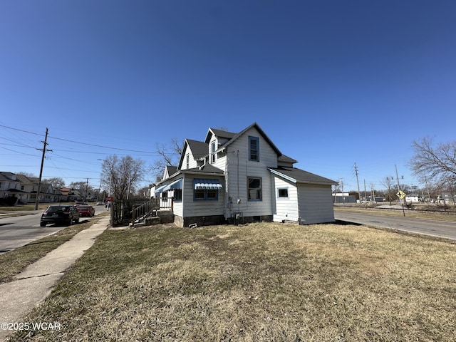 view of property exterior featuring a lawn