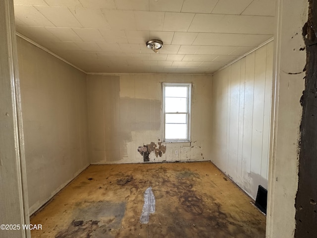 empty room with unfinished concrete flooring