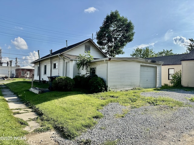 702 W Vine St, Lima, OH 45804 - view of front of house featuring an attached garage, a front yard, and gravel driveway