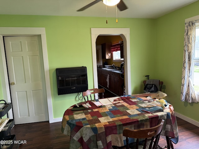 702 W Vine St, Lima, OH 45804 - dining space featuring heating unit, dark wood-style floors, a ceiling fan, and arched walkways