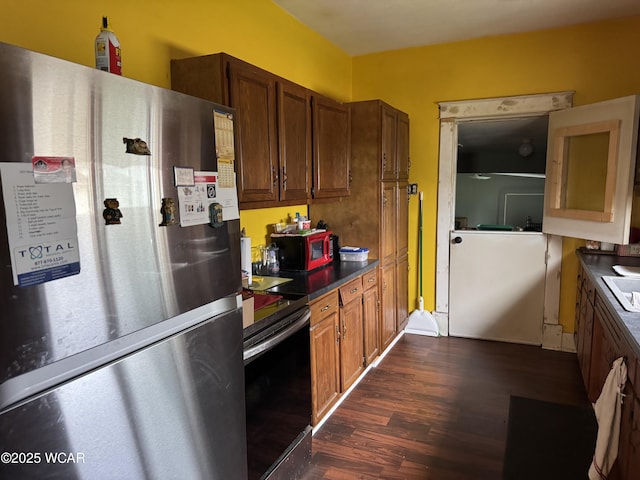 702 W Vine St, Lima, OH 45804 - kitchen featuring stainless steel appliances, dark wood-type flooring, and dark countertops