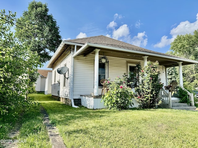 702 W Vine St, Lima, OH 45804 - view of front of home featuring a porch, a front yard, and roof with shingles