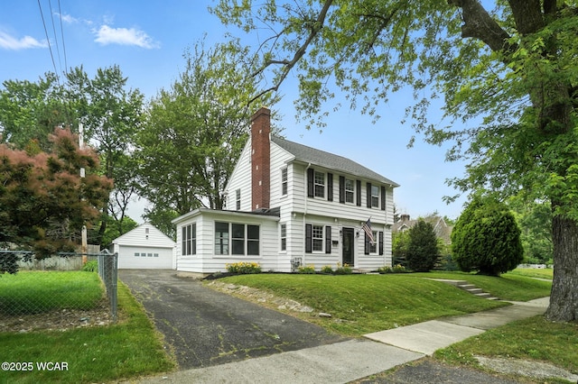 418 S Judkins Ave, Lima, OH 45805 - colonial-style house featuring an outbuilding, a chimney, and a detached garage