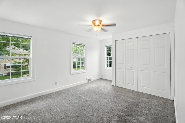 418 S Judkins Ave, Lima, OH 45805 - unfurnished bedroom featuring multiple windows, carpet, a closet, and ceiling fan