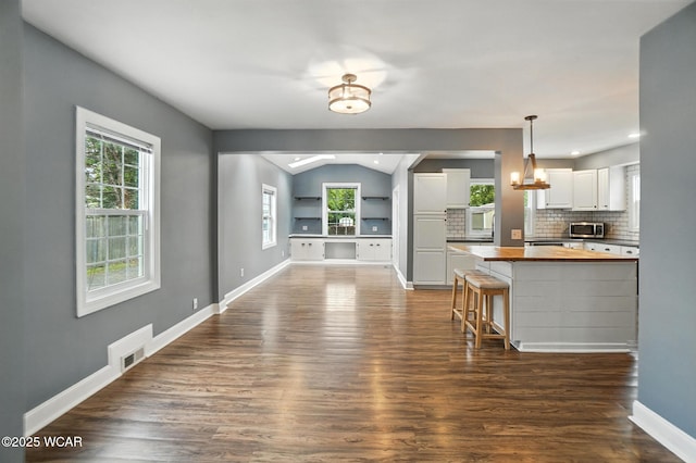 418 S Judkins Ave, Lima, OH 45805 - kitchen with wooden counters, white cabinetry, dark wood finished floors, plenty of natural light, and vaulted ceiling