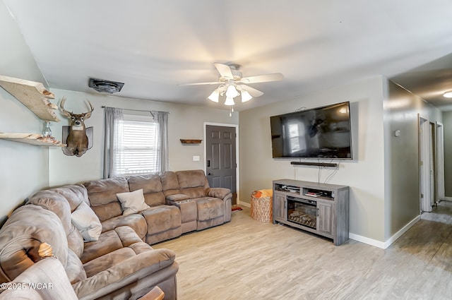 living room featuring ceiling fan and light wood-type flooring