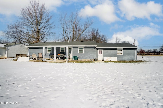 view of snow covered rear of property